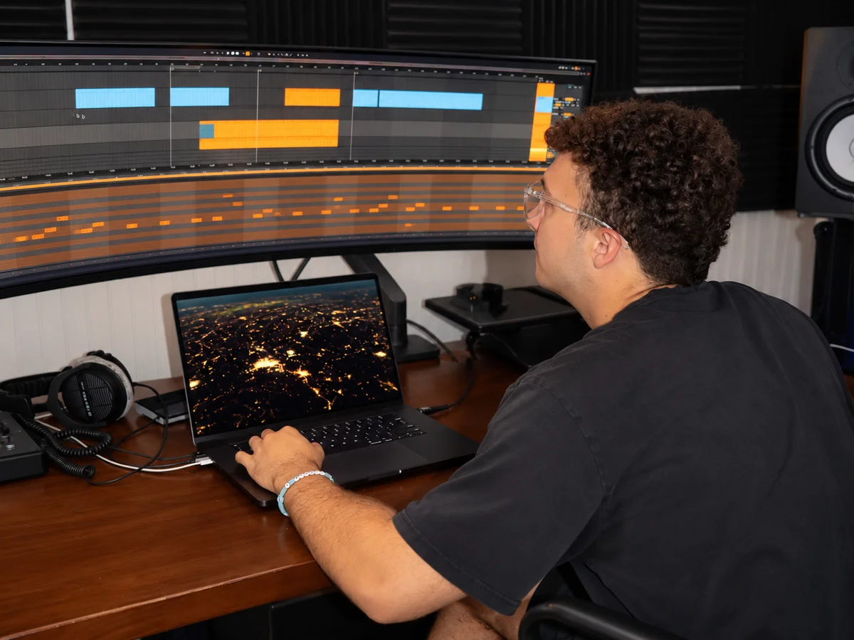Alex enjoying his music production hobby at his studio desk