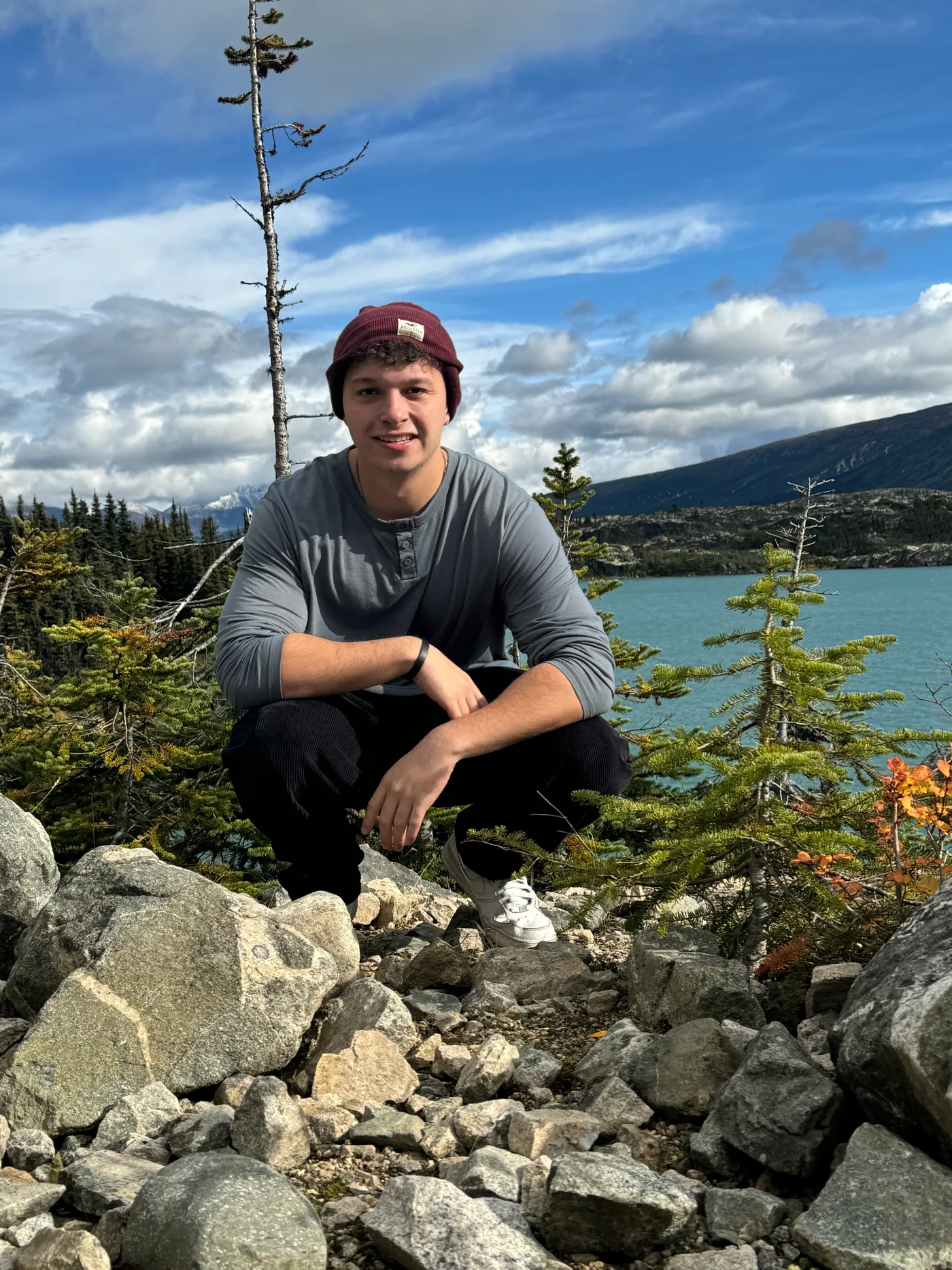 Alex Garcia outdoors beside a mountain lake